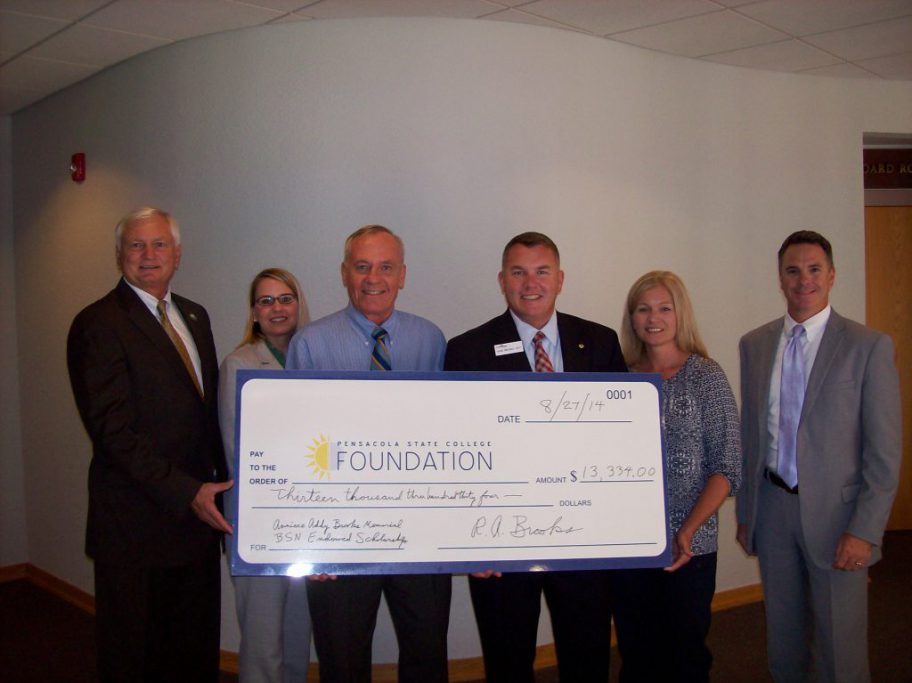 decorative image of Brooks_check-signing , Commander Robert Brooks, presents PSC with a gift of $13,334 2014-11-13 14:02:44