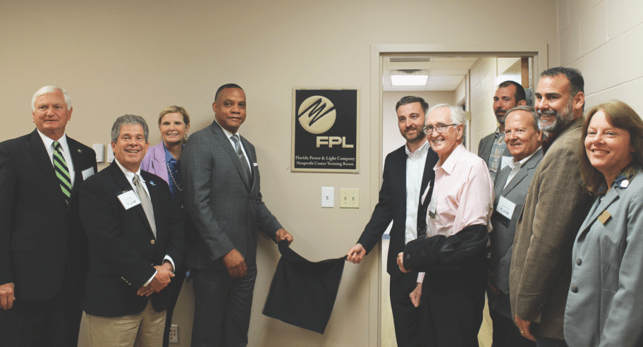 Pensacola State College Nonprofit Center Dedication Group of people unveiling plaque at Pensacola State College Nonprofit Center.