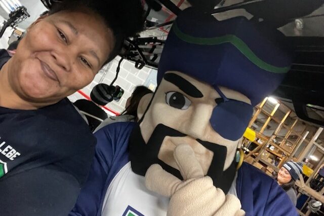Person with mascot at Pensacola State College Foundation event.