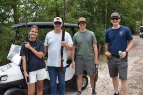 Group of four young adults at Day of Clays 2025 event, outdoors.