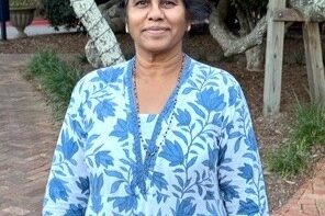 Woman in blue patterned blouse at Pensacola State College Foundation event.