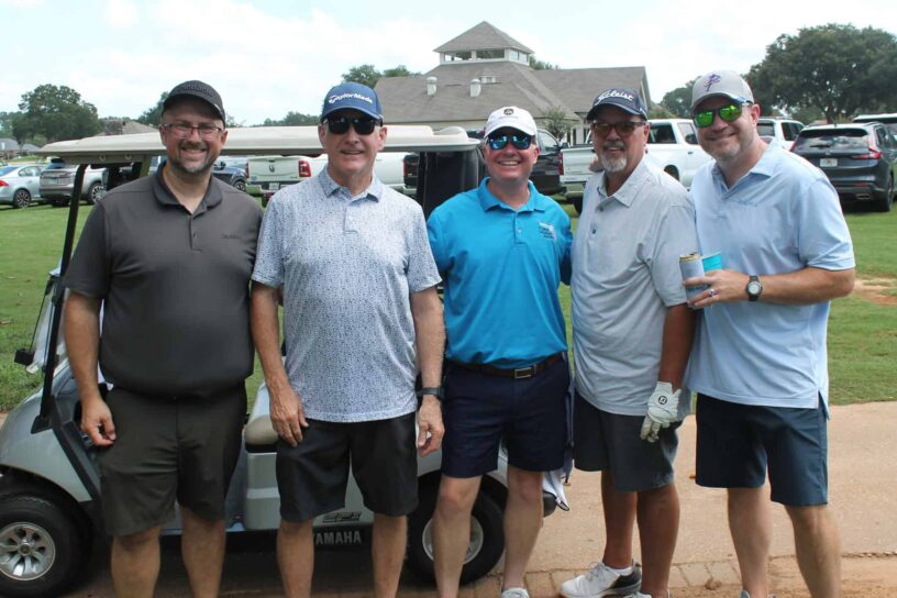 Scott Beckwith, Joey Moye, Gerry Miles, Randy Bricker, and Rick McClanahan of Team Florida Insurance Agency pose together on a golf course.