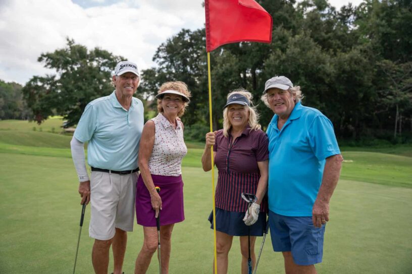 Bob Weir, Vicki Weir, Wanda Radcliff, and Brian Finkbone of Team Jenn Del Gallo pose together on a golf course.