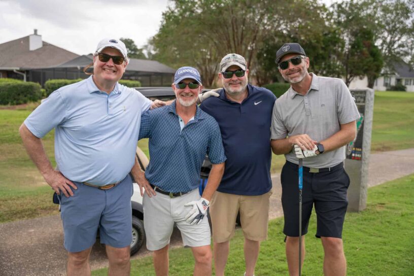 Ed Wonders, Russ Parris, Chris Cox, and Kylle Shoemaker of Team Marsh McLennan Agency pose together on a golf course.