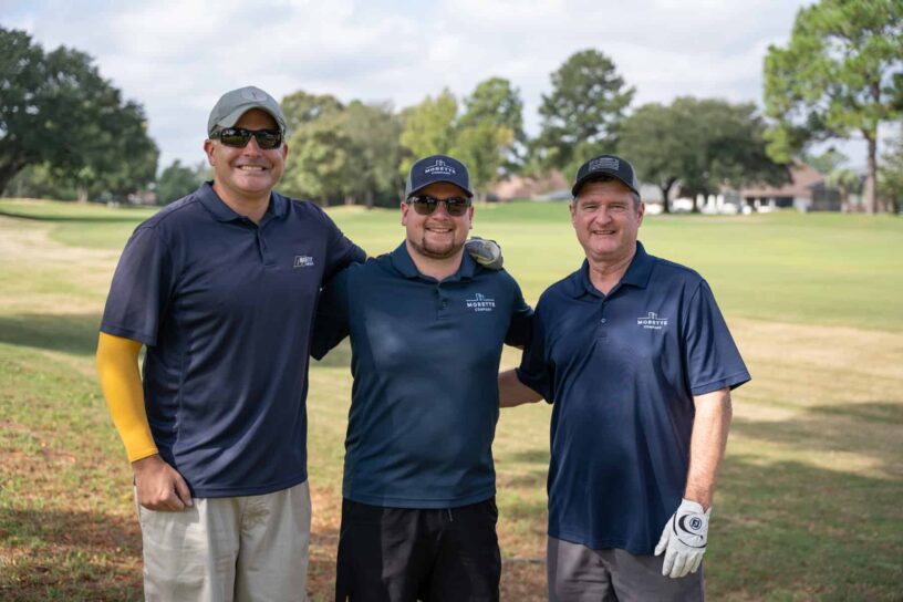 Matt Comerford, Ryan McGriskin, and Gordon Gunn of Team Morette Company pose together on a golf course.