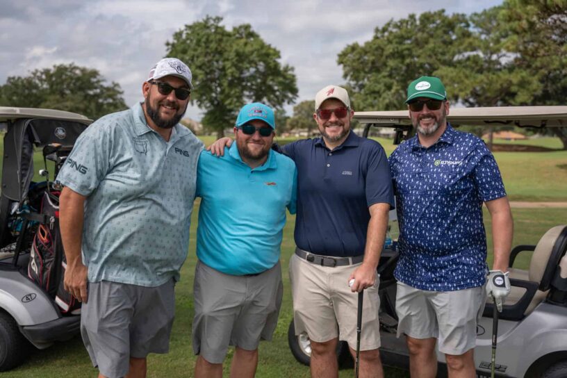 Jason Courtney, Mat Davis, Trevor Hadder, and Glenn Lovett of Team PUTT Pirates pose together on a golf course.