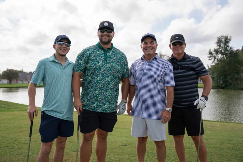 Kyle Wilson, JT Granat, Wade Wilson, and Kevin Hubbard of Team Veterans National Homecare #3 pose together on a golf course.